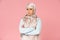 Pensive muslim woman in hijab with crossed arms, isolated on pink