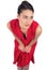 Pensive mysterious brunette in red dress posing