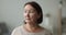 Pensive older brown-haired woman posing indoors staring into distance