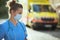 Pensive paramedic woman with stethoscope and medical mask