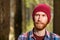 Pensive portrait of a bearded man in a red hat