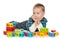 Pensive preschool boy with blocks