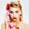 Pensive, puzzled or thinking woman with phone tube. Unhappy pin up girl. Isolated