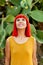 Pensive red haired woman in a park