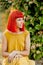 Pensive red haired woman in a park