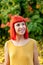 Pensive red haired woman in a park