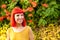 Pensive red haired woman in a park