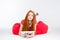 Pensive redhead young woman using tablet