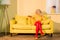 pensive retro styled woman with broccoli on plate resting on sofa at bright apartment doll