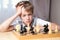 Pensive teenager playing chess