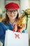 Pensive trendy woman in glasses with egg and shopping bag