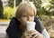 Pensive woman with coffee contemporary in a cafe on the street portrait lifestylepensive