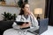 Pensive woman doctor sit at table holding clipboard with smile plan future work relax dream. Calm female medic rest look at