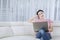 Pensive woman with laptop at home