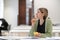 Pensive woman mature student looking into distance while studying in library, disinterested in study