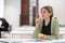 Pensive woman mature student looking into distance while studying in library, disinterested in study