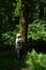 Pensive woman in a thick green forest