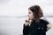 Pensive young girl looking to the sea from boat. Teenager girl at ferryboat. Cold grey sea