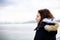 Pensive young girl looking to the sea from boat. Teenager girl at ferryboat. Cold grey sea