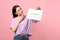 Pensive young woman holding calendar with marked menstrual cycle days on background