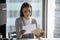 Pensive young woman read postal letter in office