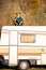 Pensively girl sits on the roof of a retro camper