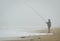 Penthievre, France - June 26, 2012. Fisherman fishing in fog on coast in Bretagne