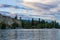 PENTICTON, CANADA - JULY 04, 2020: lake landscape with sailboats calm morning with cloudy sky