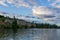 PENTICTON, CANADA - JULY 04, 2020: lake landscape with sailboats calm morning and house on the cliff