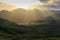 Pentland Hills mountain landscape near Edinburgh, with sunrays reflecting in a lake