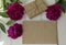 Peonies, empty notepad craft paper sheet on wooden background