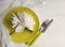 Peony flower, plate, knife restaurant white wooden background