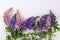 Peony flowers in clay vintage vase on old stump in meadow selective focus