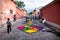 Peoople making alfombre flower carpets on the cobbled streets of Antigua, Guatemala