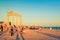 People admire beautiful sunset at ancient monumental stone arch of Temple of Apollo in Side