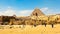 People admire the greatness of the stone Sphinx, pyramids and ancient architecture of Giza Plateau in Egypt