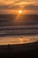 People admiring sunset at Muriwai