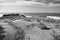 People admiring surfers on ledge of atlantic coast in portugal