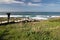 People admiring wonderful seascape and surfers on amazing atlantic ocean beach amado