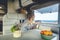 People and alternative vanlife lifestyle concept. Adult woman drinking and enjoying sea view inside camper van motorhome house