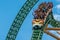 People amazing terrific Cheetah Hunt rollercoaster on lightblue cloudy sky background 71