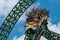 People amazing terrific Cheetah Hunt rollercoaster on lightblue cloudy sky background 78.