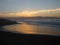 People approach the beach at sunset