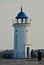 People approaching the old lighthouse on the seafront of the Mangalia city in Romania