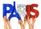 People arms hands holding up wooden letter lettering forming word Paris capital city of france in french national flag colors