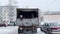 People in the back of a truck in winter. Clip. Truck drives slowly through a residential area with passengers.