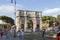 People on the background of the Arc de Triomphe of Emperor Constantine in Rome