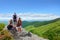 People with backpacks hiking on summer trip in mountains.