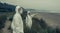 People in bacteriological protective suits watching the sea