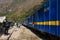 People and baggages on railway track to Machu Picchu, Peru